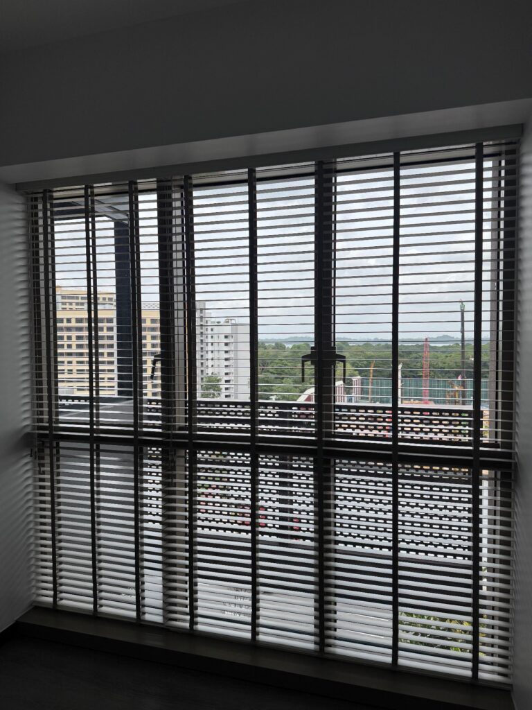 Dark timber venetian blinds on a full-height window with a Singapore city view