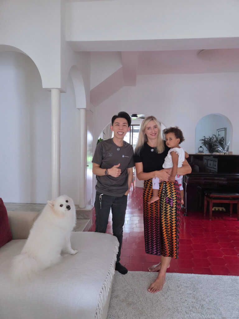 The Curtain Expert with a family and their dog in a Singapore landed home