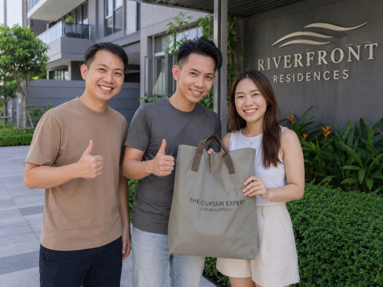 Three happy customers holding a The Curtain Expert bag outside Riverfront Residences condominium in Singapore